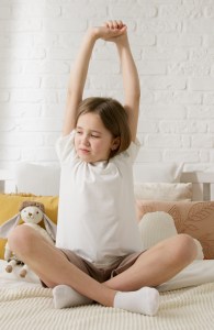 girl on bed stretching