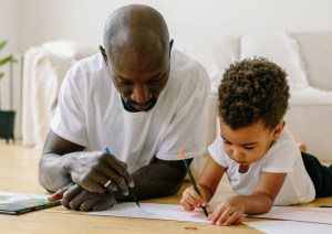 Dad and son drawing together