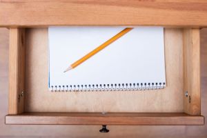 Notepad and pencil in bedside drawer