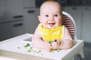 Baby eating brocolli