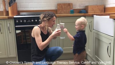Mum offering toddler two different bottles Copyright Children's Speech and Language Therapy, Cardiff and Vale UHB